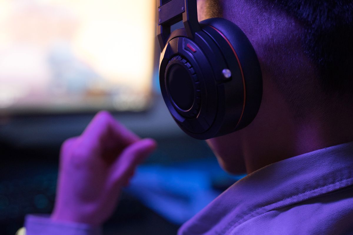 A person wearing glasses and a gaming headset