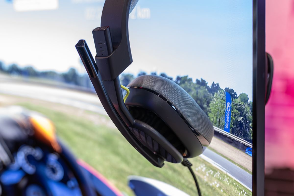 A gaming headset resting on a monitor stand