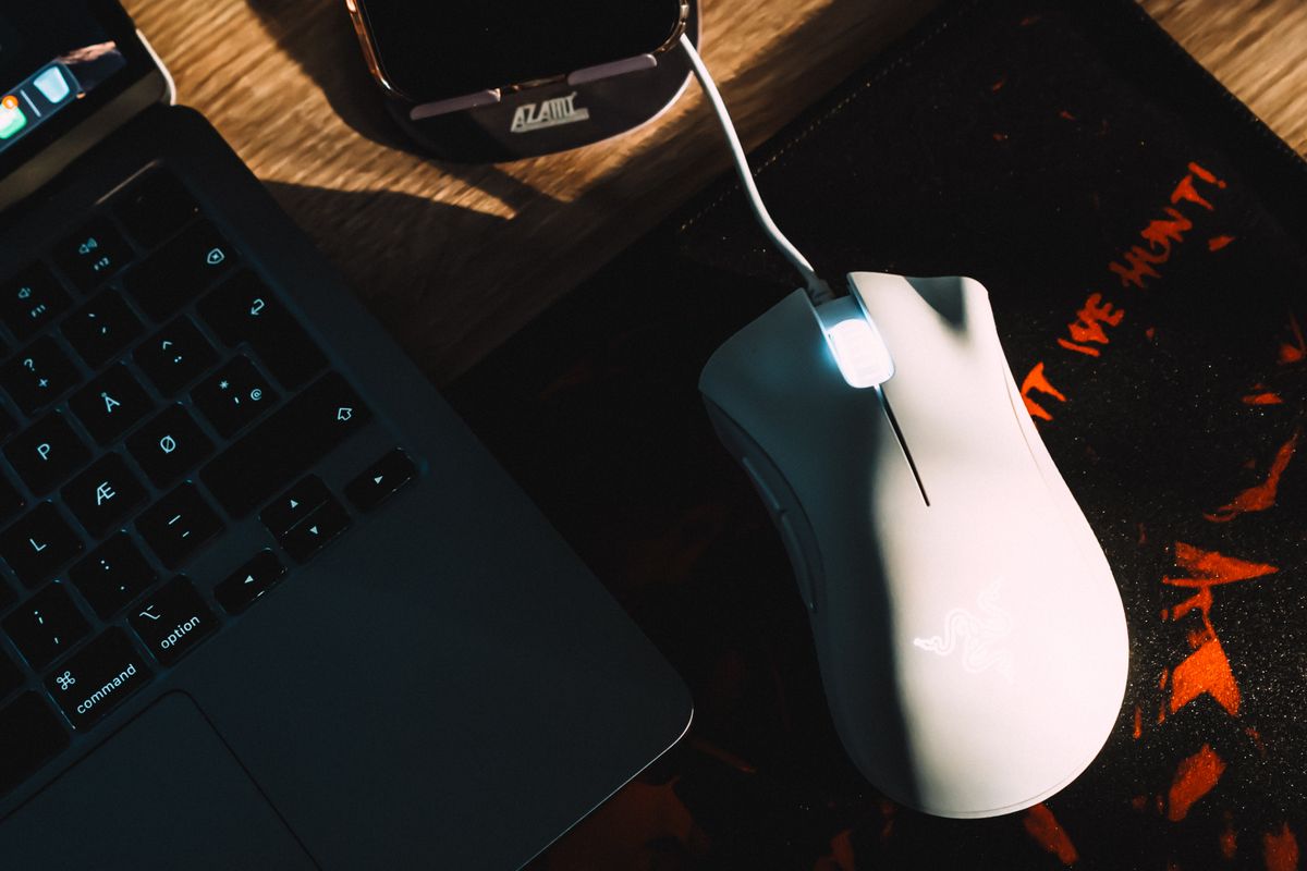A large desk-sized mousepad under keyboard and mouse