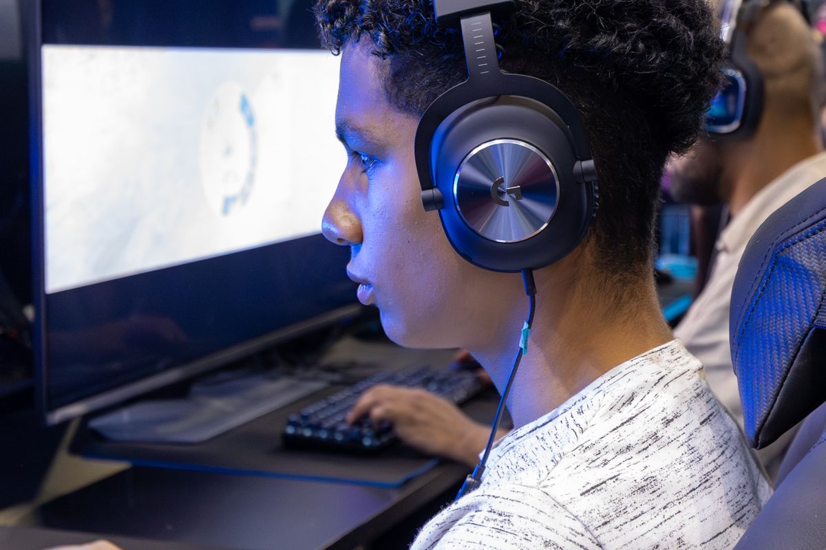 A wireless gaming headset with its USB dongle